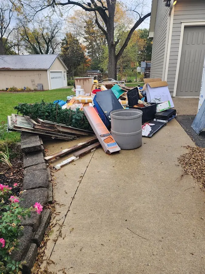 Dumpster being loaded with debris for Commercial Dumpster Rental in Liberty Hill
